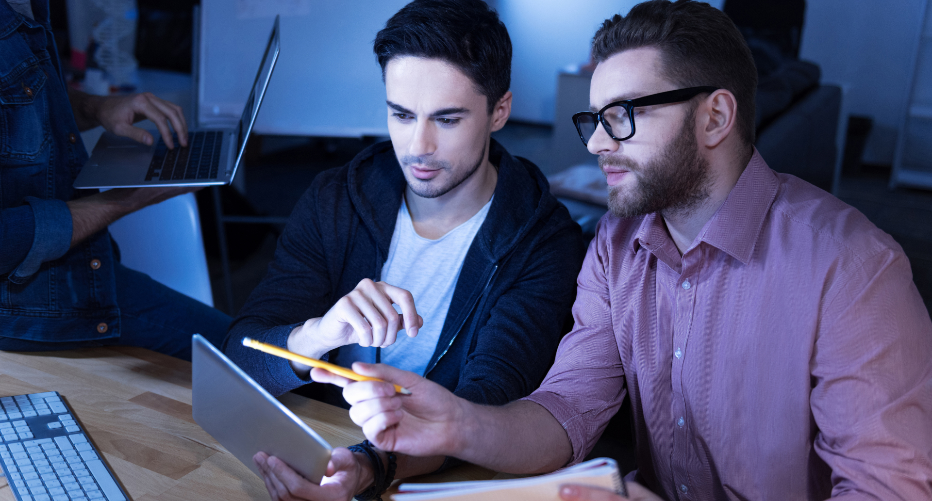 IT audit review with business charts and laptop showing professionals analysing IT audit data.